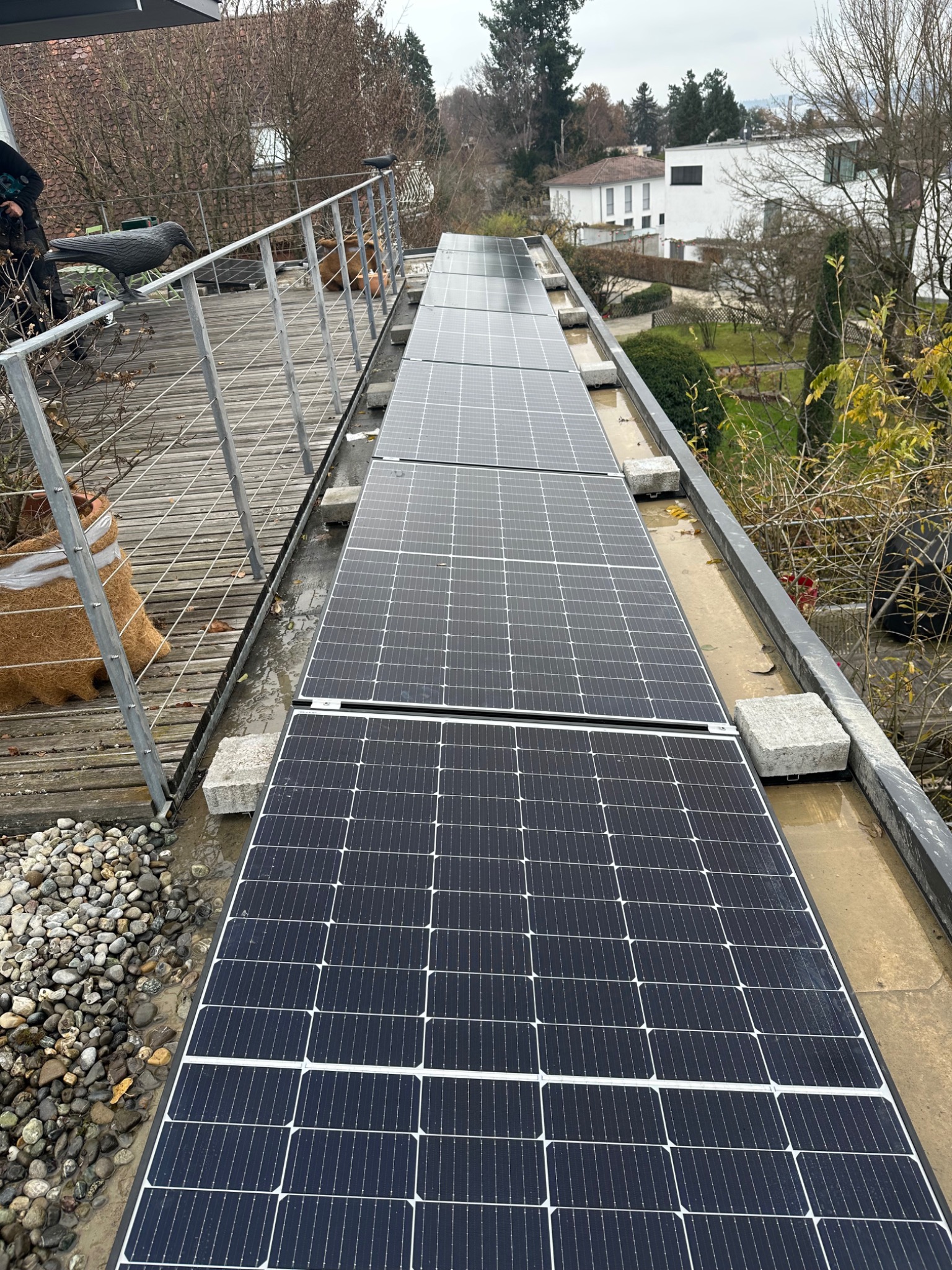 Solarmodule auf einer schmalen Dachfläche neben einer Dachterrasse